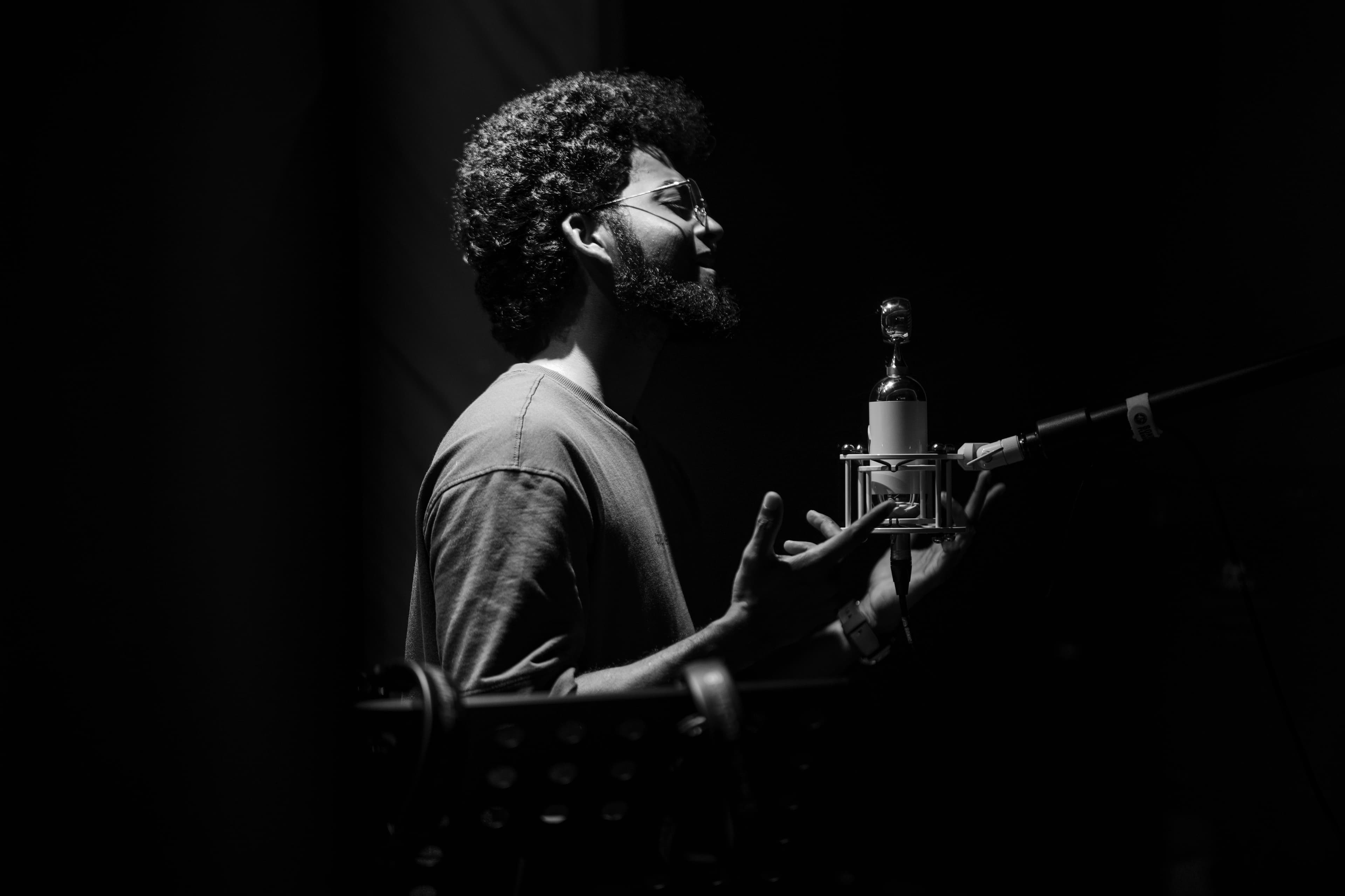 Vocalist singing into a studio microphone at Abylon, Kerala